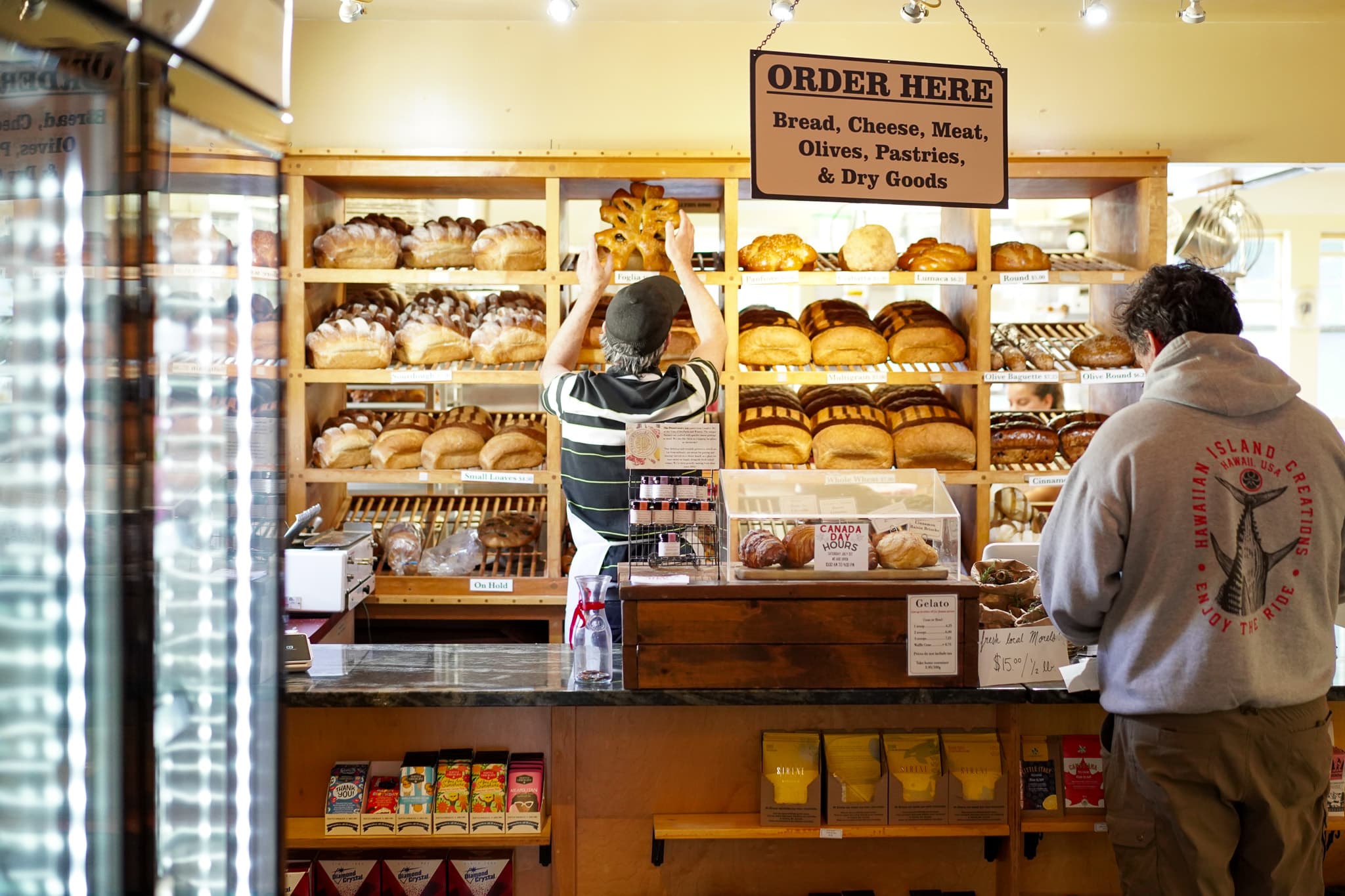 Fresh bread on wooden shelves at Ottavio Italian Bakery